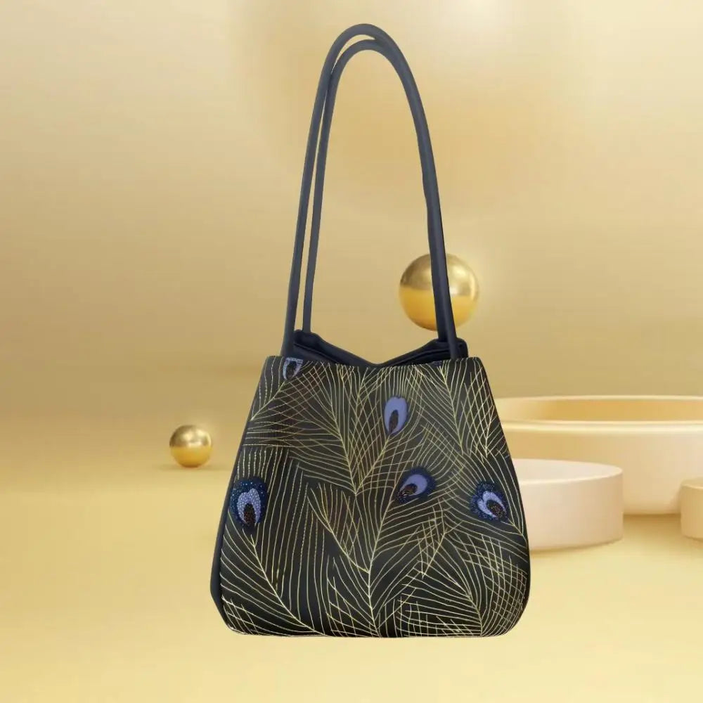 Handmade black silk designer handbag featuring intricate gold peacock feather Suzhou embroidery and thin shoulder straps.