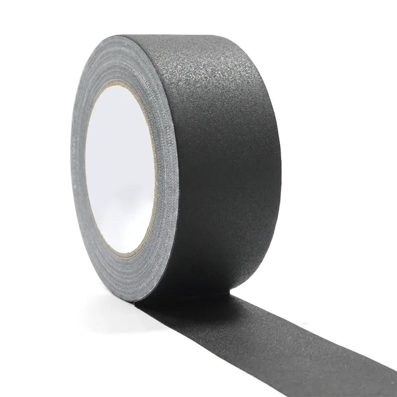 Black matte gaffer tape roll with tape pulled outward along the side