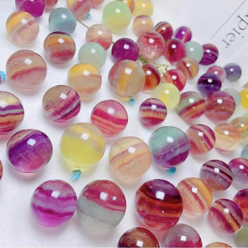 Fluorite crystal spheres, dense mix of glossy round stones in pink, purple, green