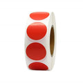 Red circular sticker label roll on white backing, side view