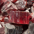 Loose red and clear rough cubic zirconia pieces, uncut faceted stones close-up