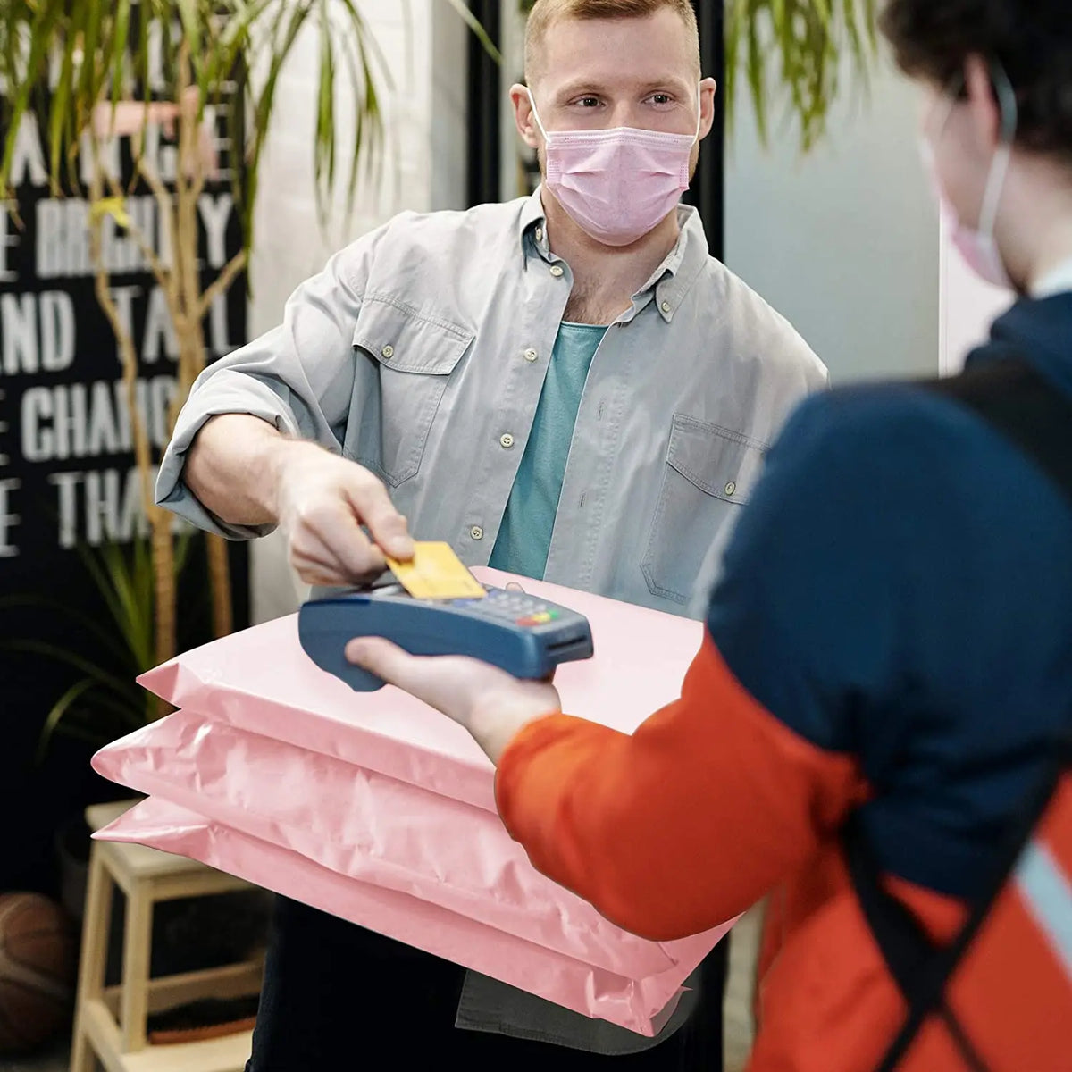 Pink poly mailer with built-in handle during delivery, plastic shipping bag