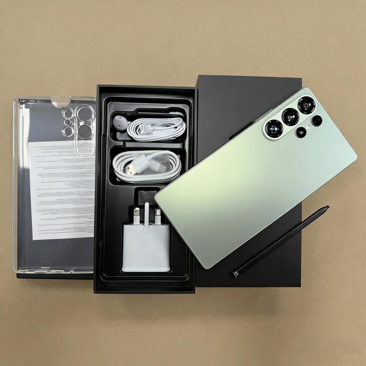 Unlocked smartphone in light green with four rear cameras; open box with accessories