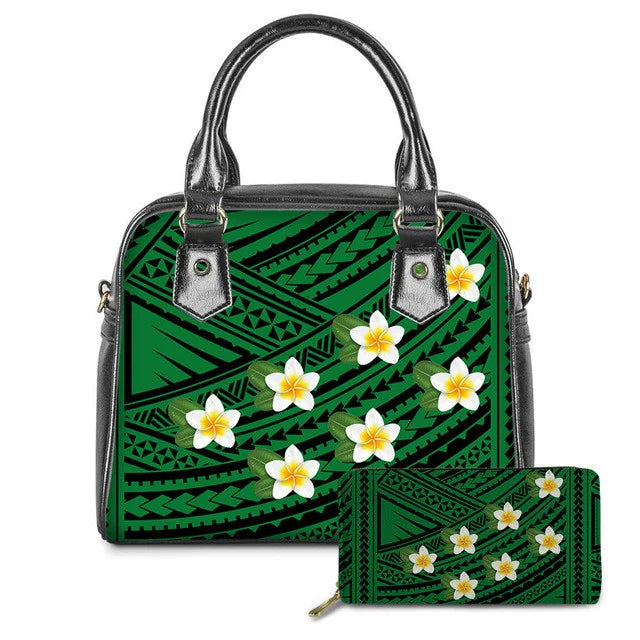 Green Polynesian tribal print leather handbag and matching wallet set with white and yellow plumeria flower accents.