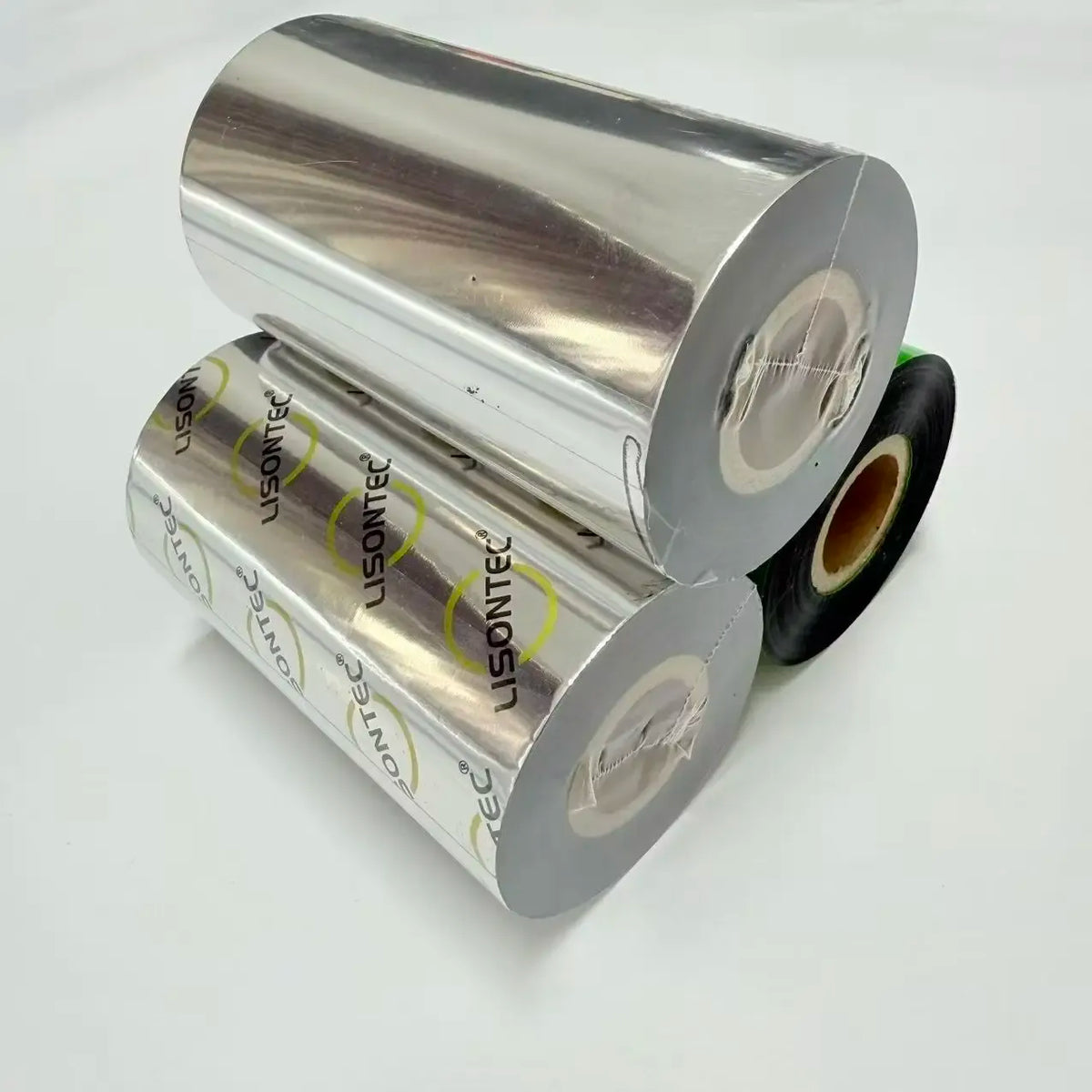 Thermal transfer ribbon rolls on silver cores; printed label on inner backing