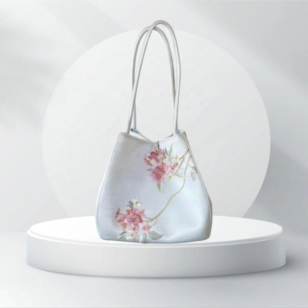 Handmade designer silk handbag in light blue with delicate floral Suzhou embroidery and twin shoulder straps.