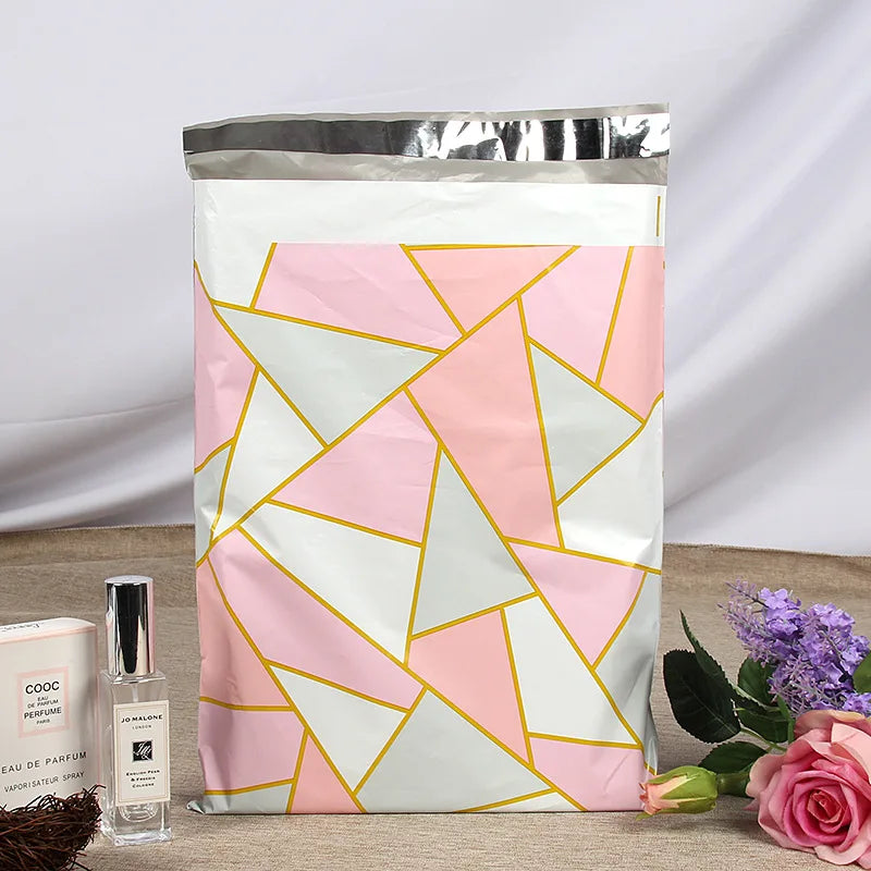 Pink and white geometric pattern poly mailer bag with silver top strip