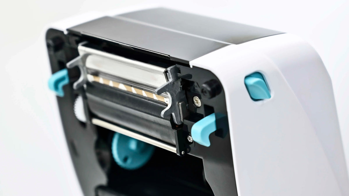 Direct thermal printer print head area with label feed and blue guides