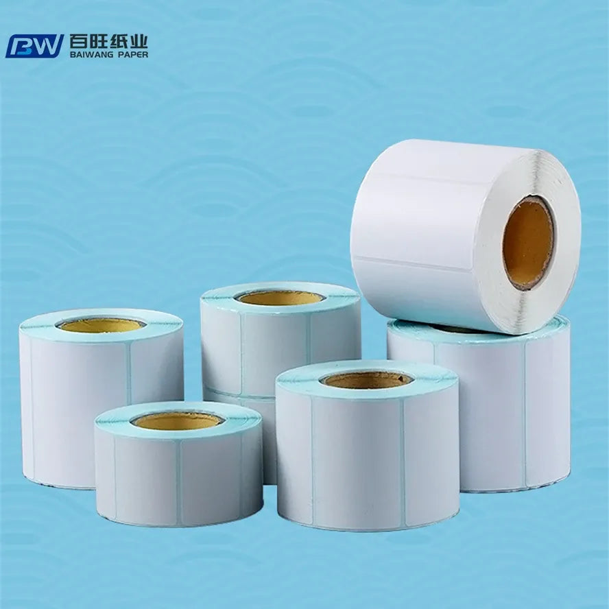 Adhesive shipping label rolls in white and light blue, multiple rolls arranged