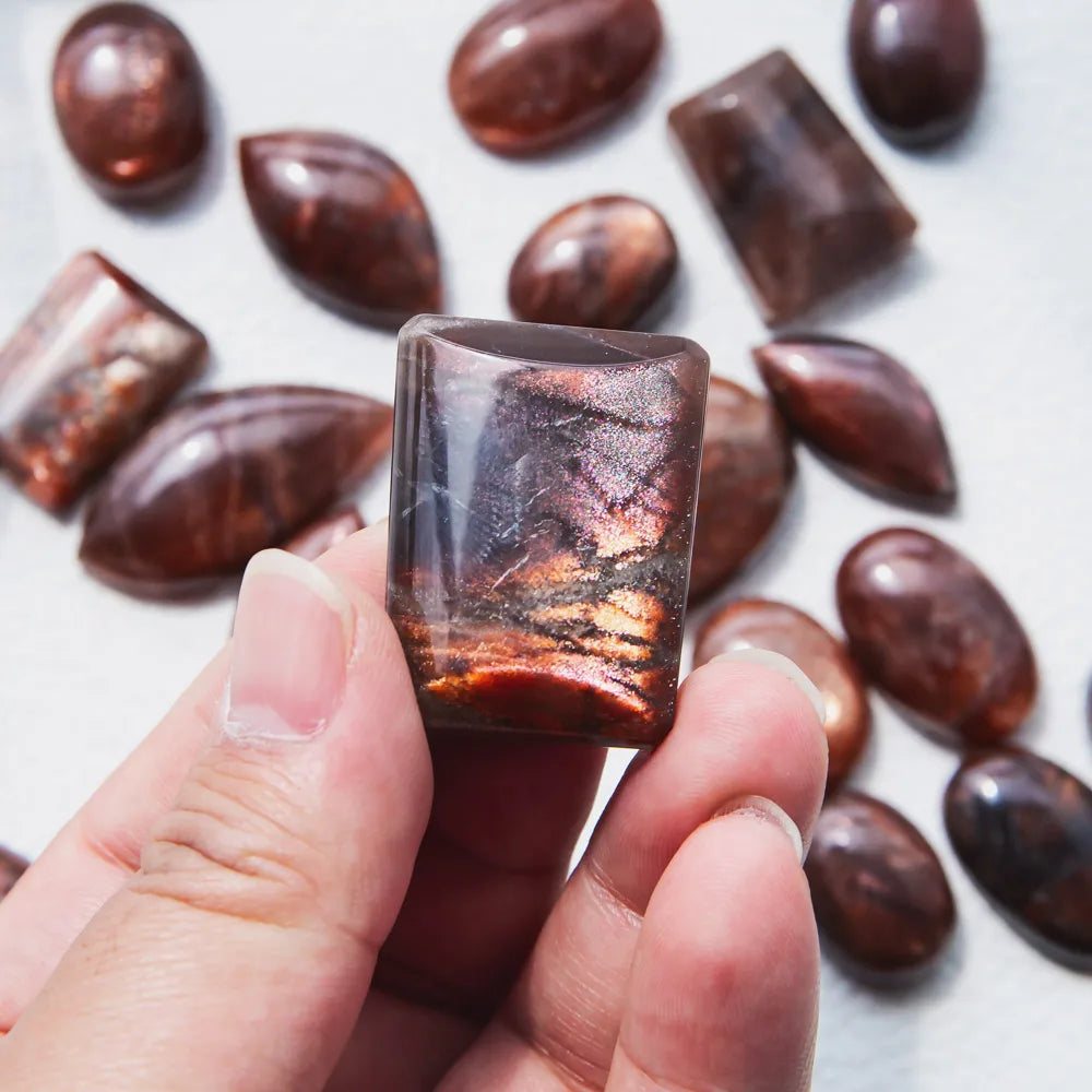 Handheld golden sunstone square pendant crystal with glossy dark-red and orange sheen