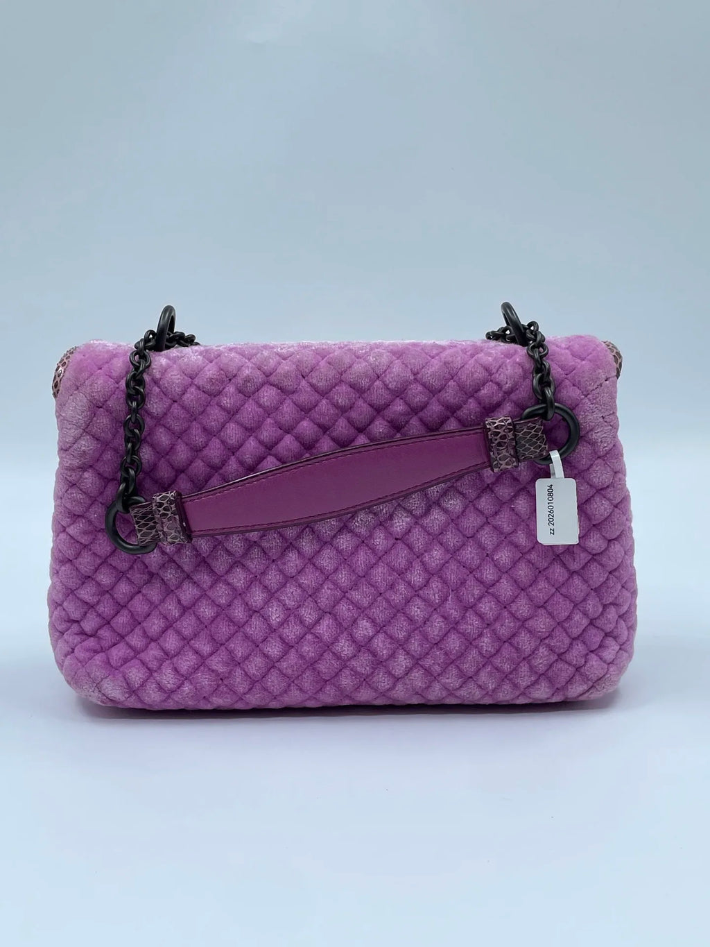 Luxury purple velvet shoulder bag with quilted texture, dark metal chain strap, and snakeskin-patterned leather accents.