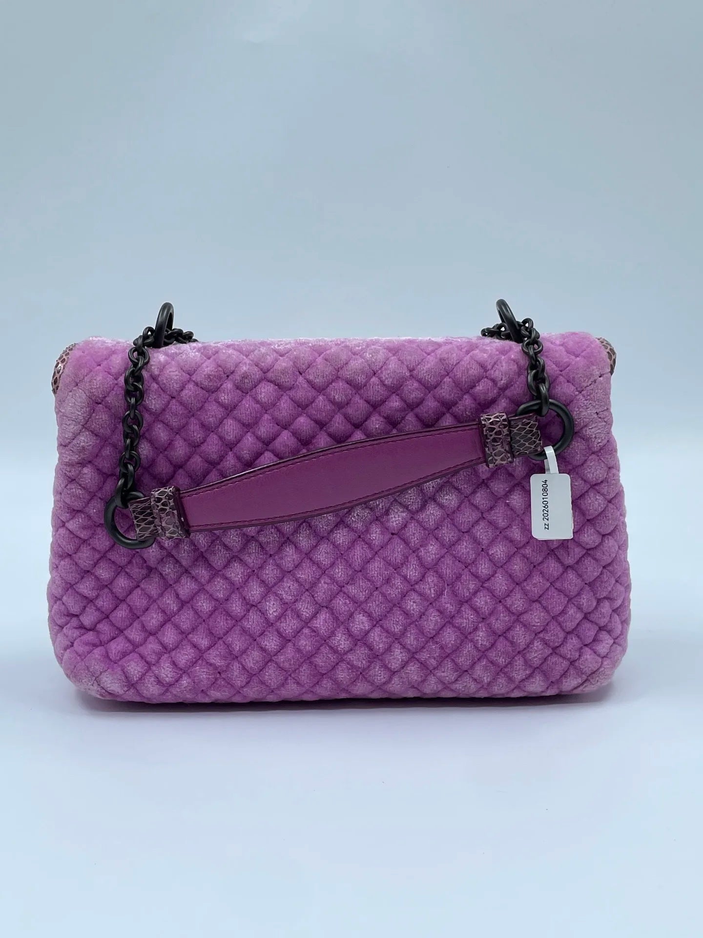Luxury purple velvet shoulder bag with quilted texture, dark metal chain strap, and snakeskin-patterned leather accents.
