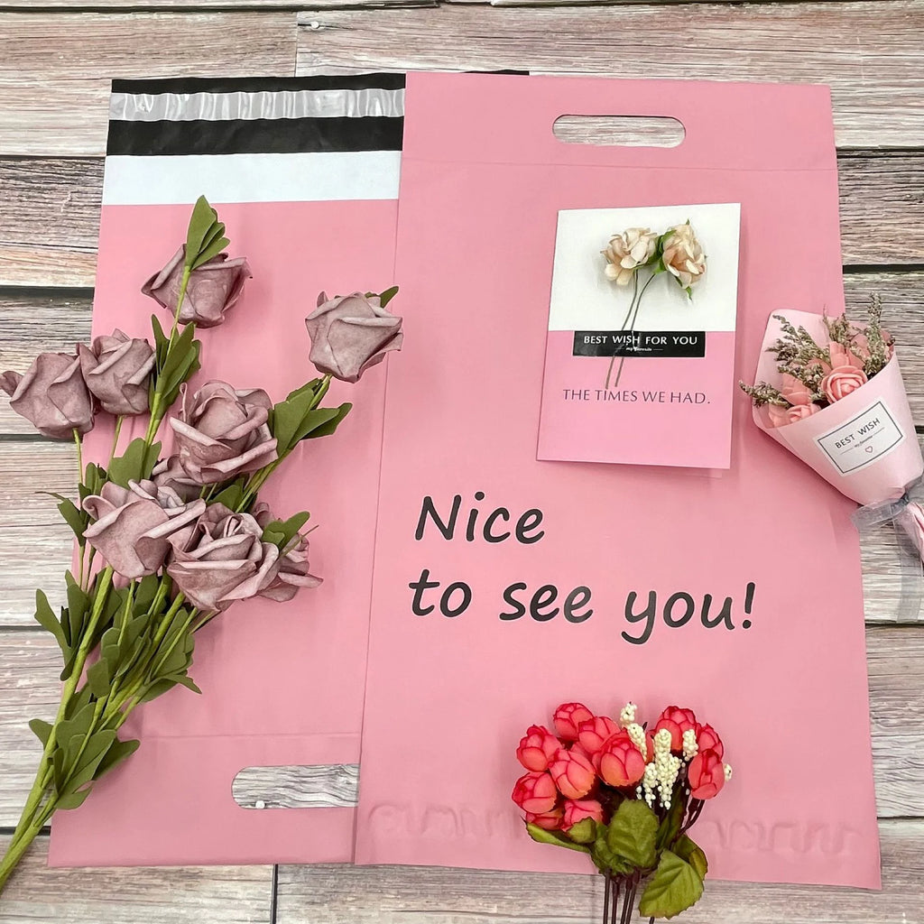 Pink poly mailer bag with side handle, floral print, and “Nice to see you!” text