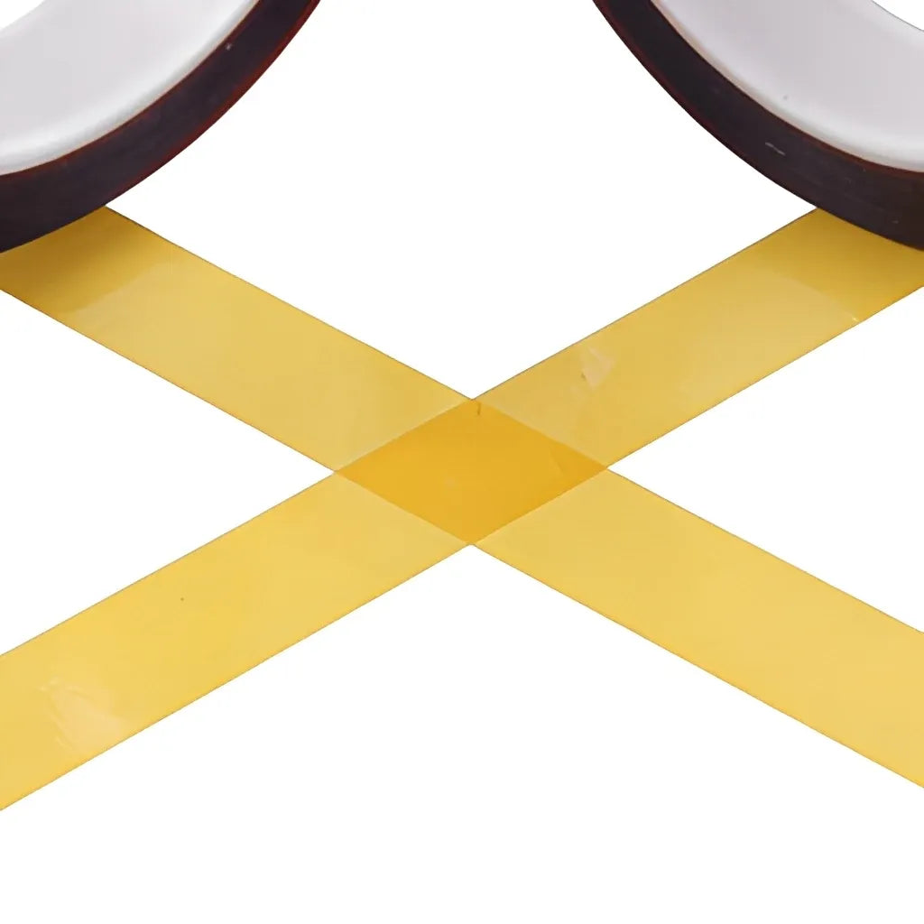Cross-shaped die-cut strips of yellow adhesive tape with dark outer ring edges