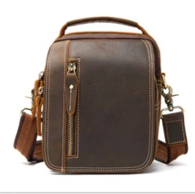 Dark brown genuine leather designer handbag, vertical zip pocket, sturdy handle, and detachable shoulder strap.