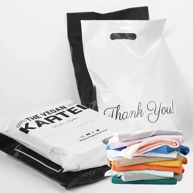 White and black poly mailer bags with handle, “Thank You!” script print on white bag.