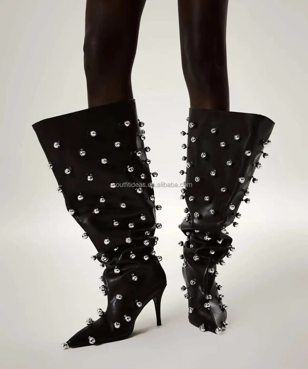 Black leather slouchy knee-high boots with silver stud embellishments, pointed toe, and slim stiletto heel.