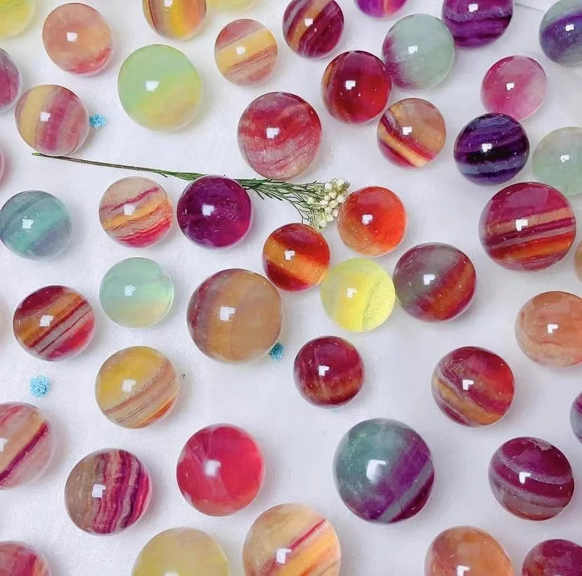 Fluorite crystal spheres, colorful striped round stones with small floral sprig