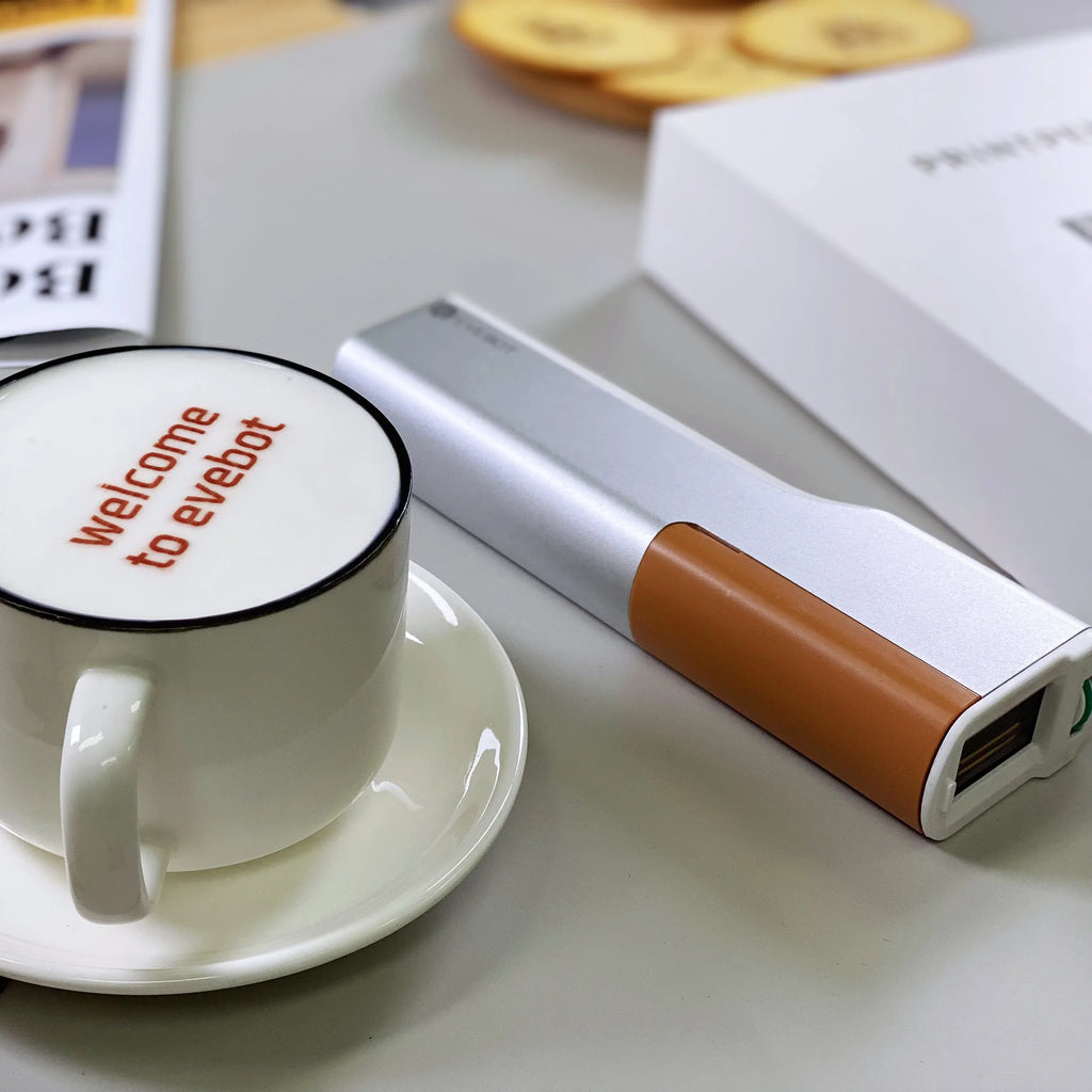 Handheld inkjet printer with silver body and brown ink cartridge