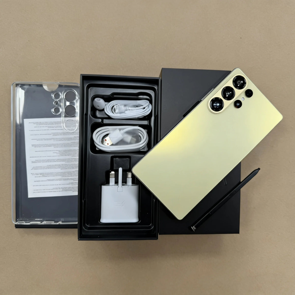 Unboxed S26 Ultra 5G smartphone set: phone back, cables, charger, and manual in box.