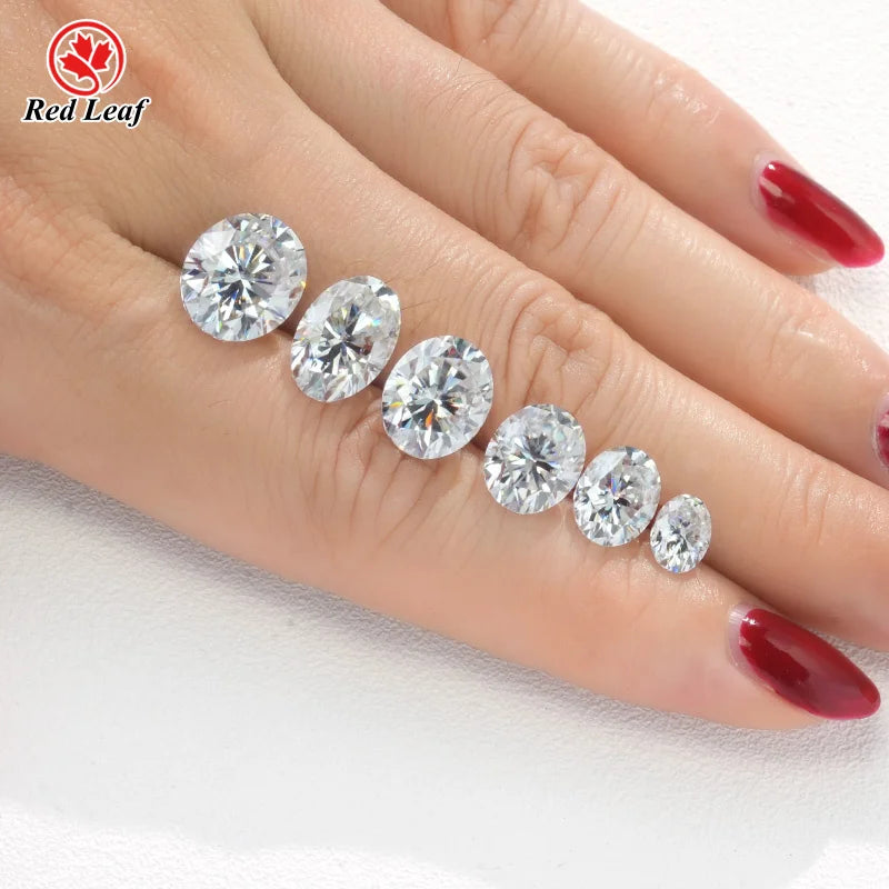 Oval lab-grown diamonds, clear stones on hand in a row for loose gem use
