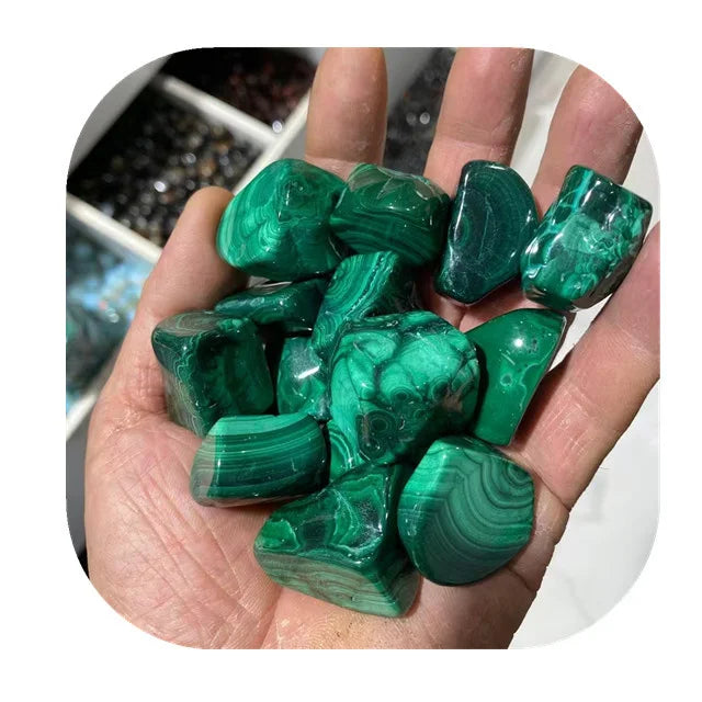 Handful of green malachite tumbled stones with swirling, banded patterns