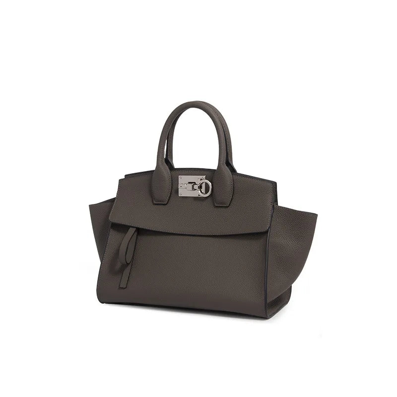 Taupe genuine leather luxury designer tote bag with silver metal clasp and structured handles.