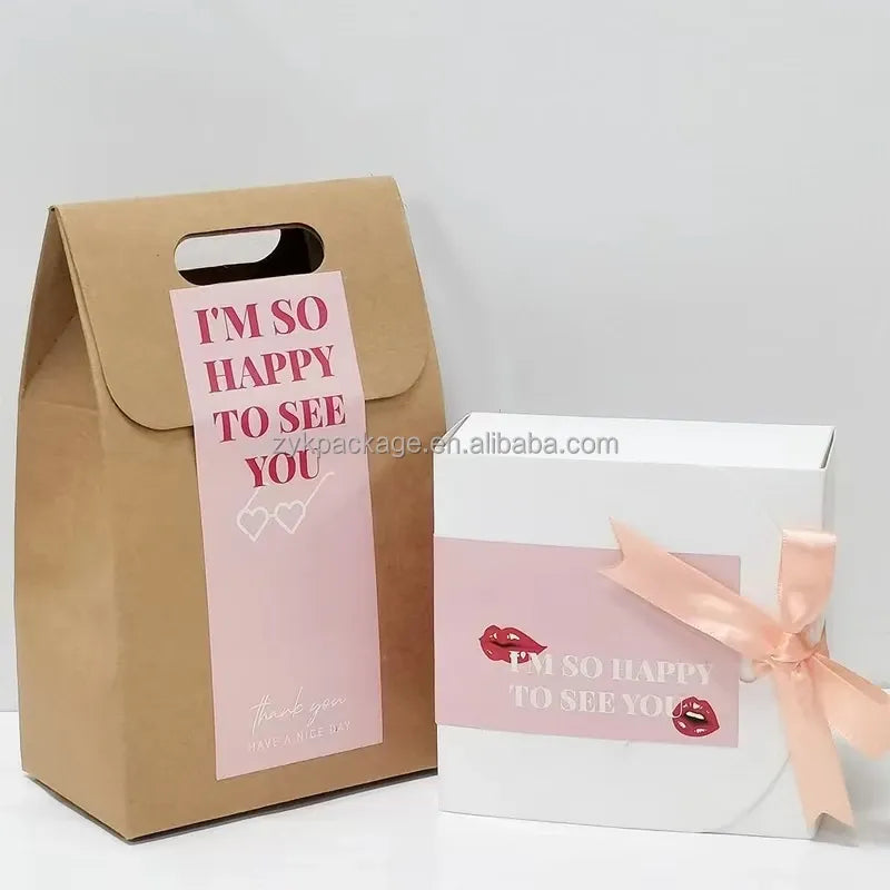 Pink “I’m so happy to see you” sticker on a gift box with a ribbon bow.