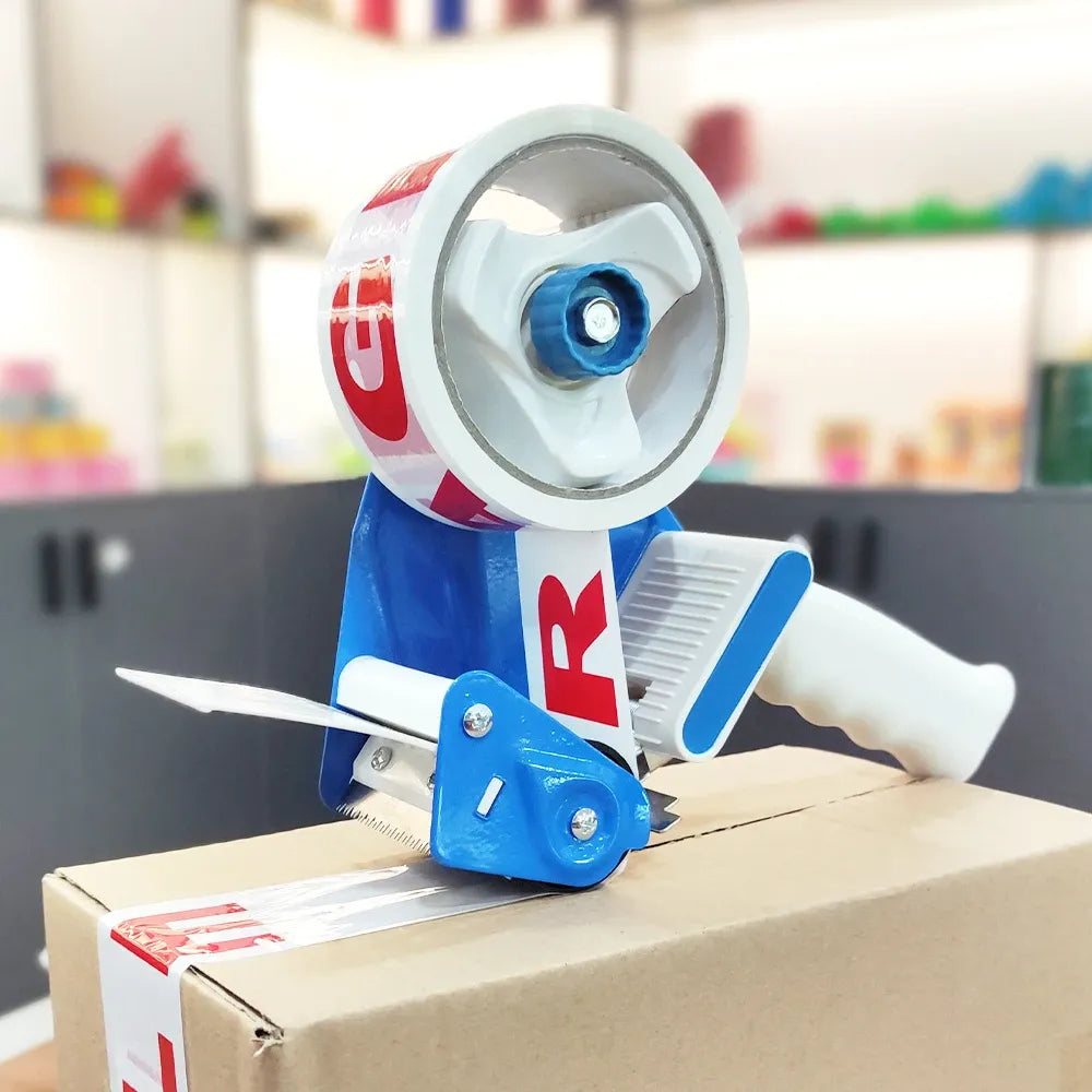 Printed clear packing tape dispensing to seal a cardboard box with a blue tape gun