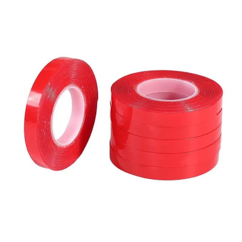 Red double-sided polyester tape rolls, one tall roll and one smaller roll with cores