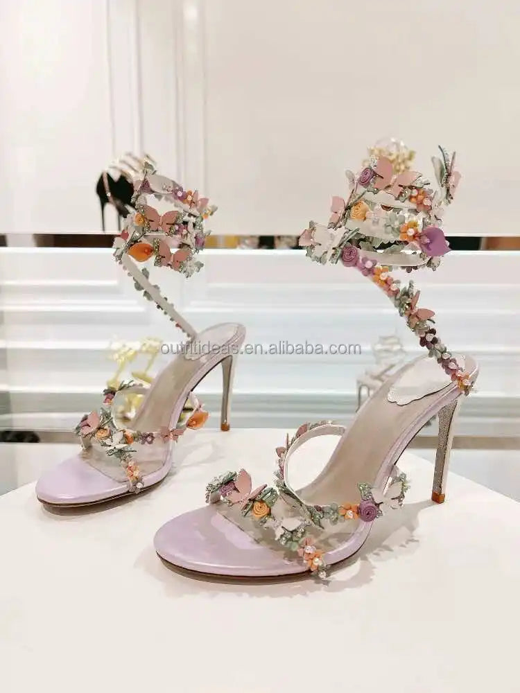 Lavender stiletto bridal heels with floral butterfly embellishments and wrap-around ankle straps. Luxury evening shoes.
