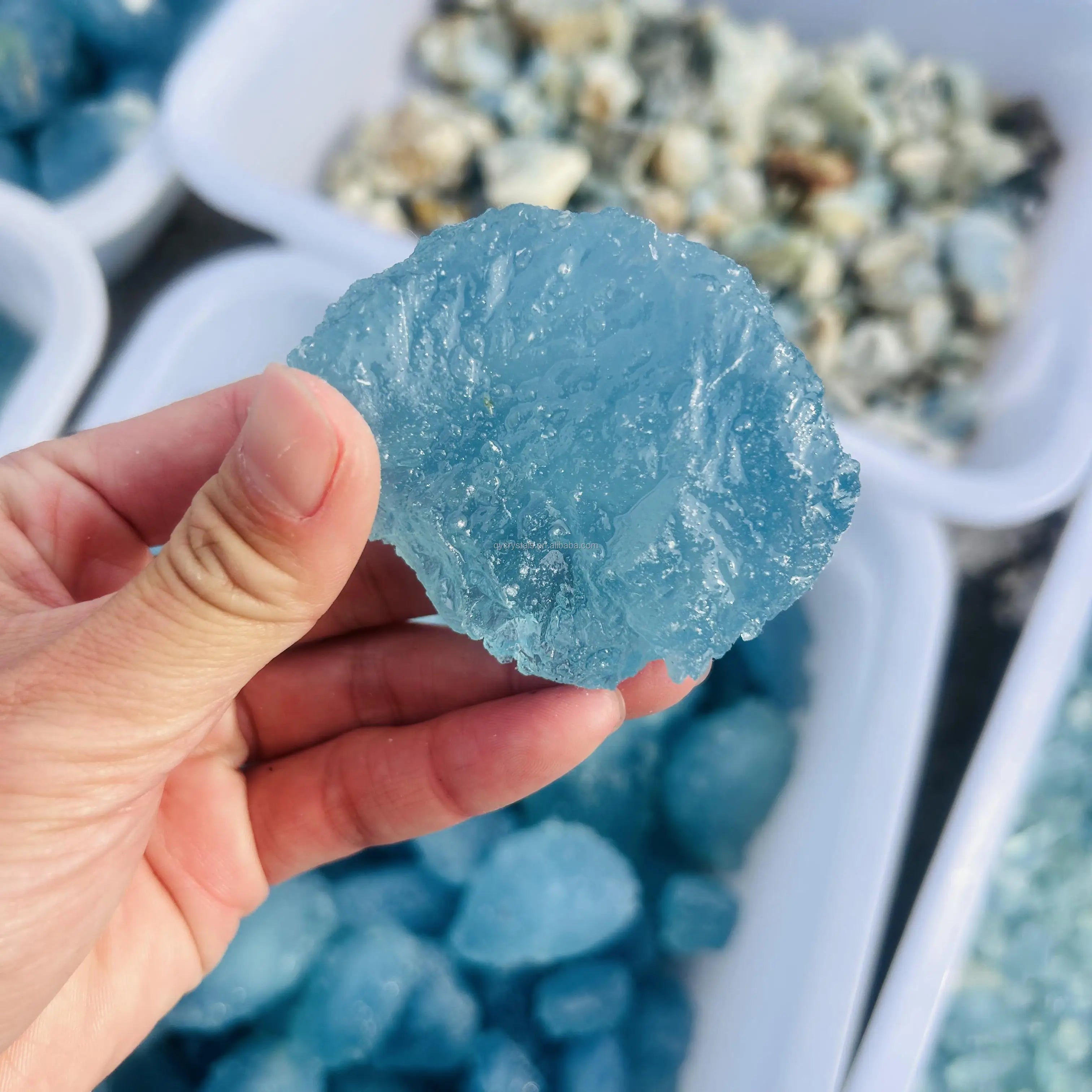 Sky blue aquamarine druzy rough crystal stone, held in hand