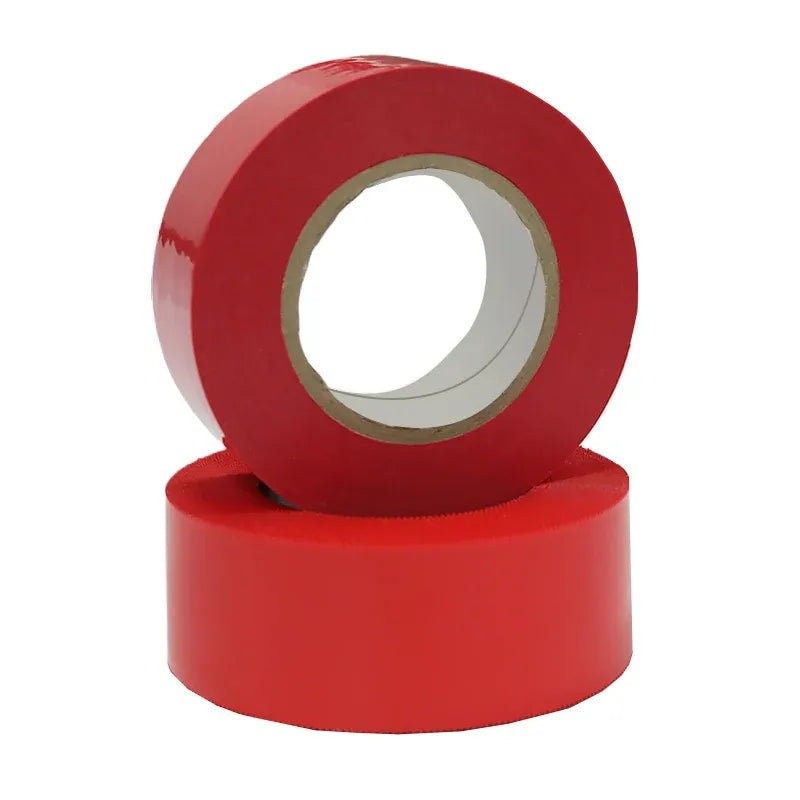 Red tape roll stacked on another roll, adhesive tape with inner core