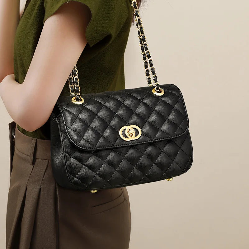 Black quilted genuine leather shoulder bag with gold turn-lock closure and chain strap for women.