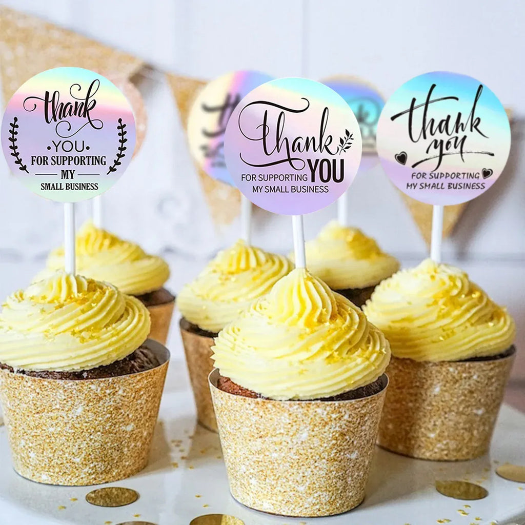 Holographic round thank-you sticker toppers with script text on cupcakes