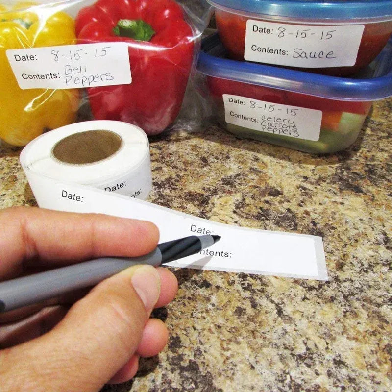 Handwriting date and contents on a white storage label strip