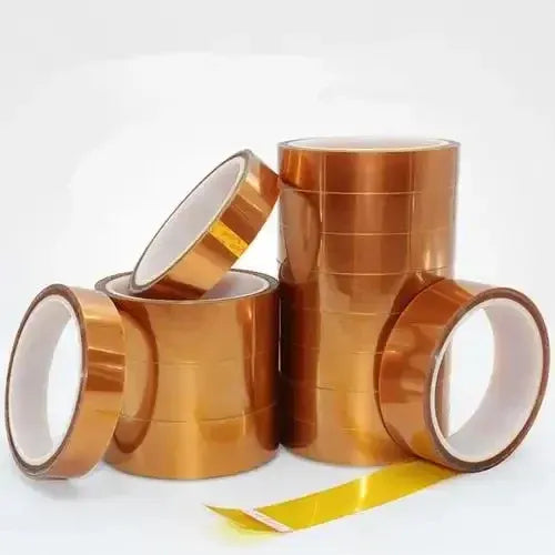 Amber-gold foil tape rolls with cut lengths, showing white release liner