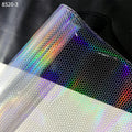 Transparent PVC film sheet with holographic snake-skin scale pattern and rainbow highlights.