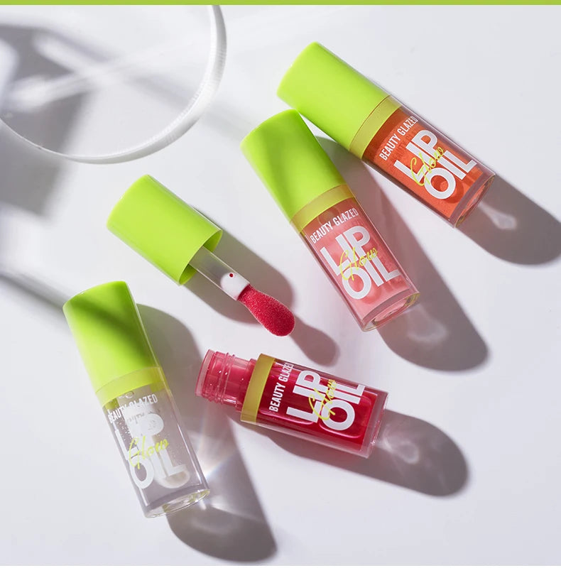Moisturizing candy lip oil set with pearlescent, lustrous mirror finish in various shades with doe-foot applicator.
