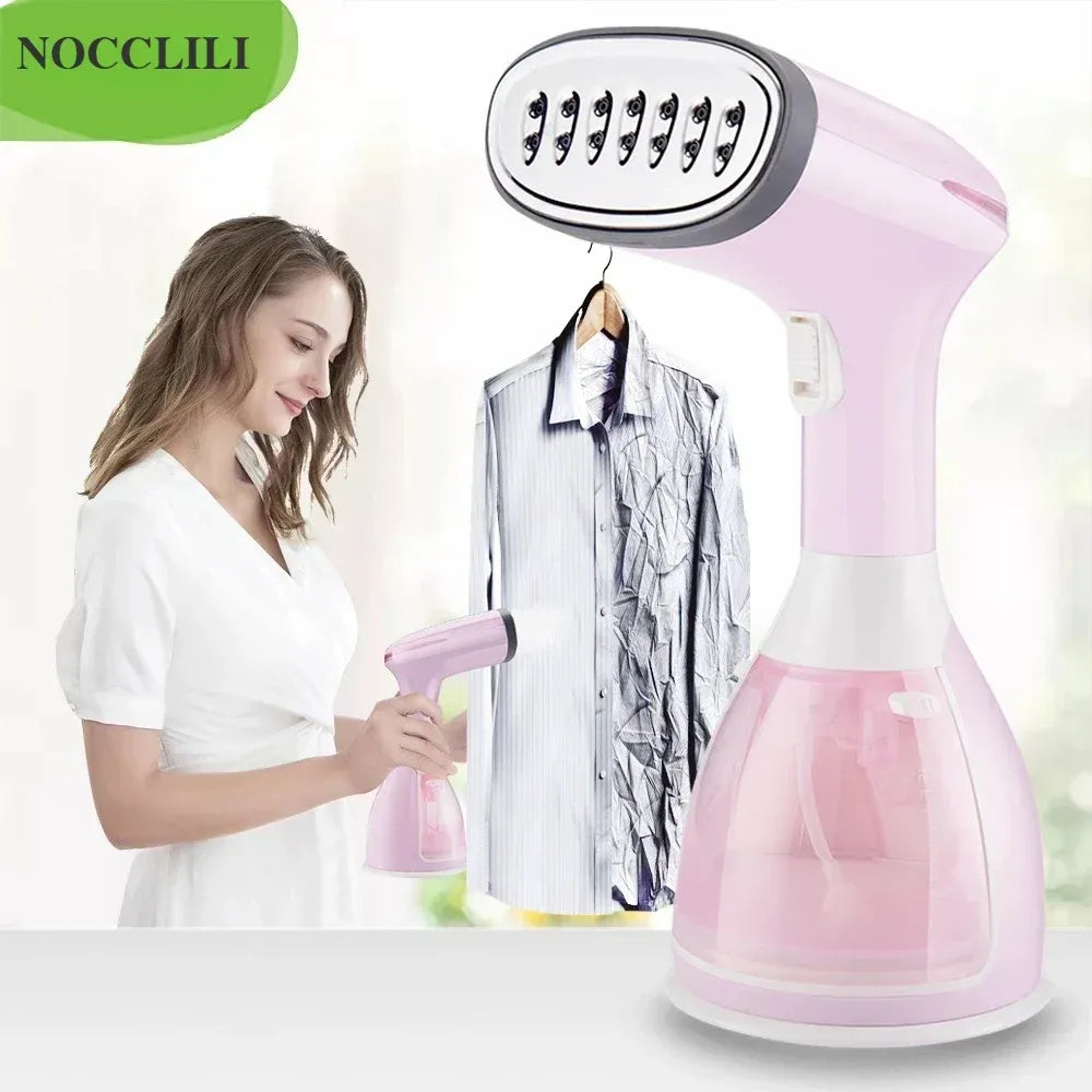 Handheld clothes steamer in pink, smoothing wrinkles on a hanging shirt.