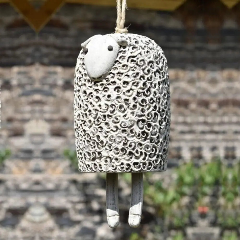 Cute white sheep resin wind chime for rustic garden decor. Decorative animal pendant for outdoor hanging and gifts.