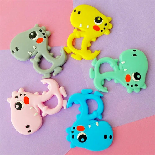 Colorful dinosaur silicone teething toys for baby relief in yellow, grey, green, pink, and blue.