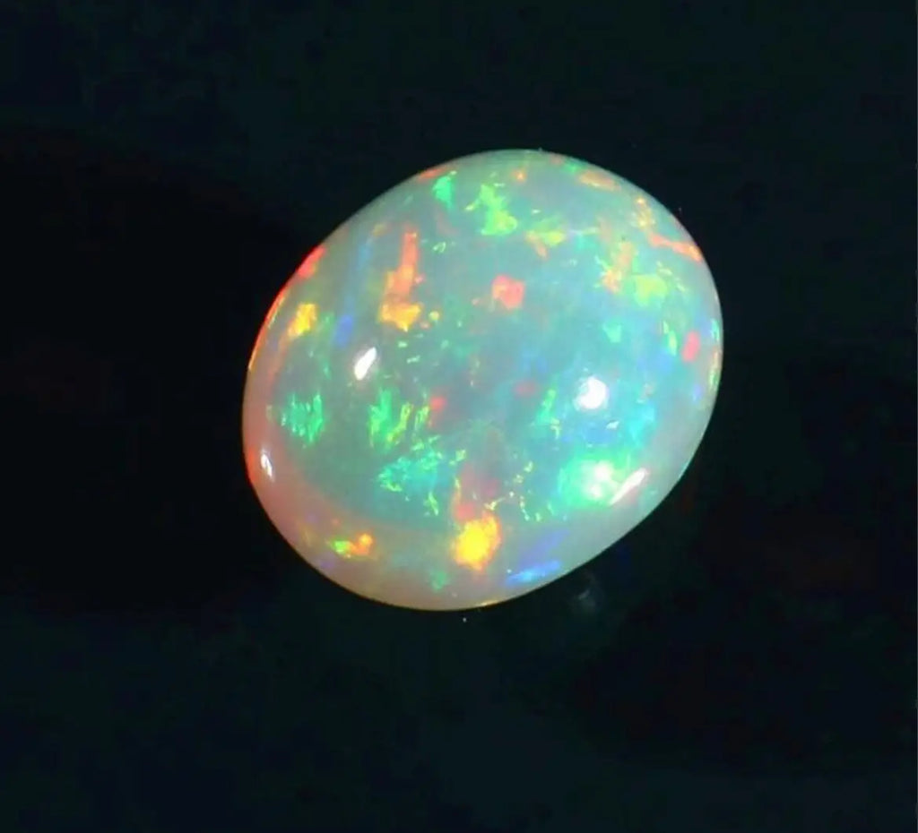 Oval opal cabochon with vivid green and orange play-of-color, glossy finish.
