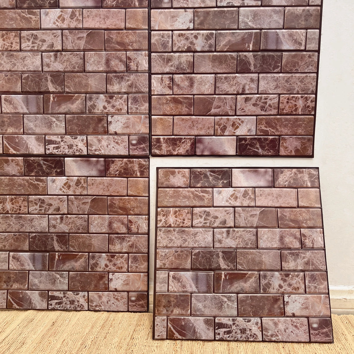 Peel-and-stick backsplash tile sheet with faux brick pattern in reddish brown and light beige