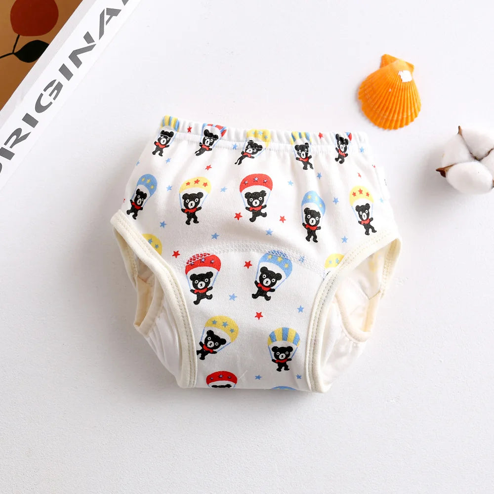 Baby care potty training diaper with cute bear and parachute print on white cotton fabric.