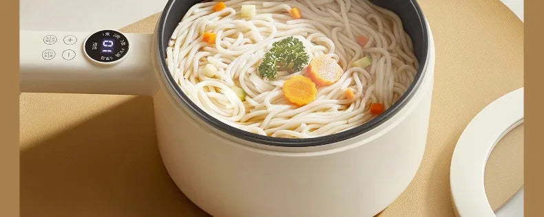 White non-stick electric cooking pot filled with noodles and toppings