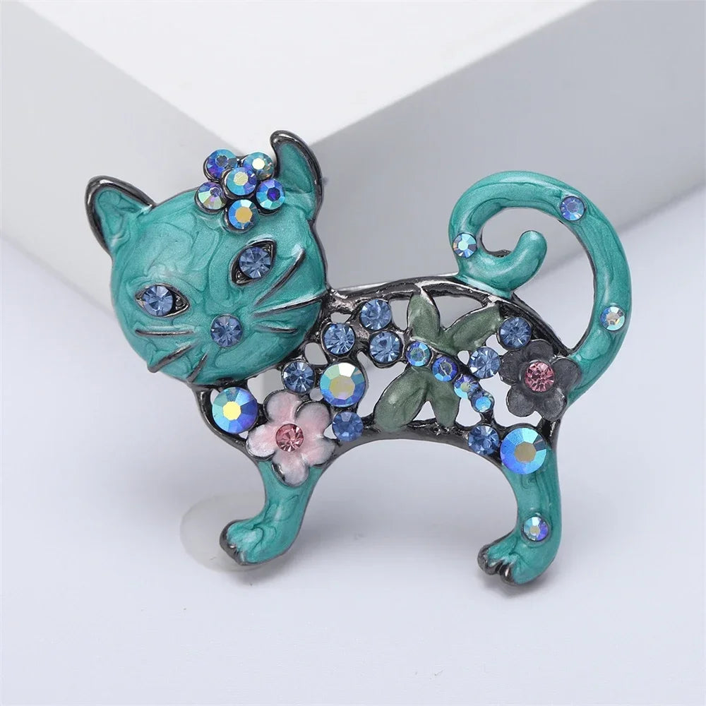 Sparkling teal crystal cat brooch pin with floral accents, perfect gift for pet lovers to accessorize coats or sweaters.
