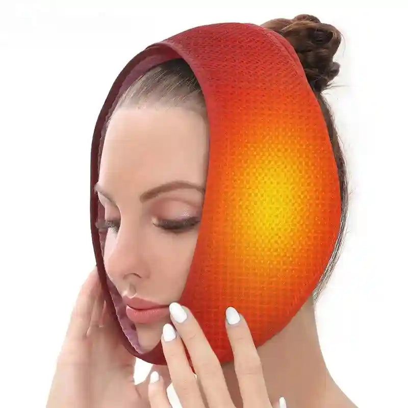 Woman wearing a red-to-orange gradient adjustable heated jaw wrap for oral surgery relief.