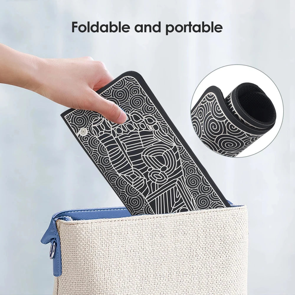 Foldable black EMS foot massager mat being placed in a bag, portable electric therapy tool for sore feet relief.