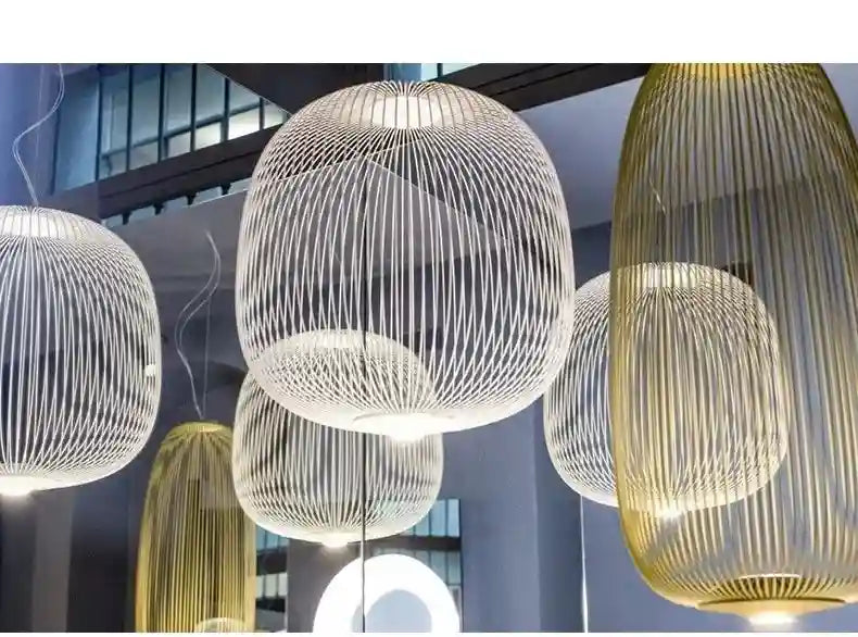 Wire cage pendant lights in white and gold, featuring rounded and cylindrical shapes for decorative interior lighting.